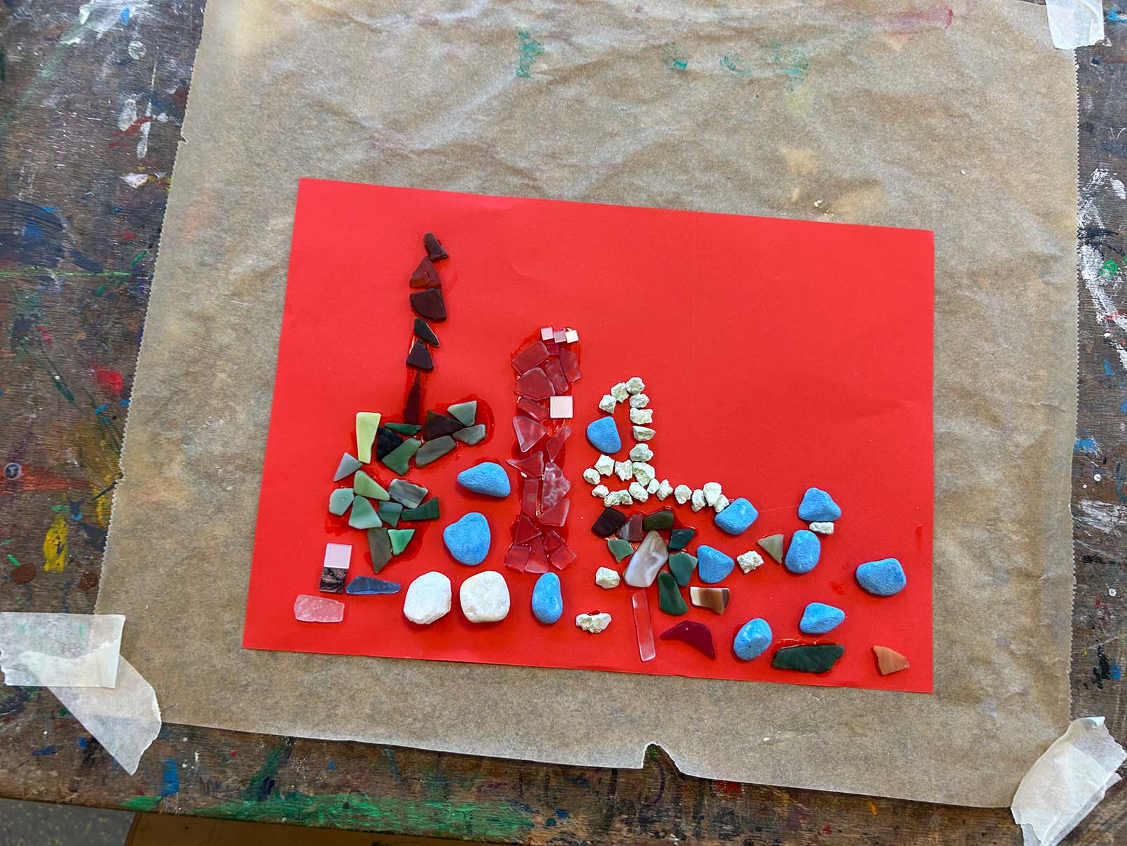 Ein Bild aus Steinen auf rotem Papier